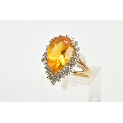 65 - A 9CT GOLD CITRINE CLUSTER RING, designed with a central claw set, pear cut citrine, within a single... 