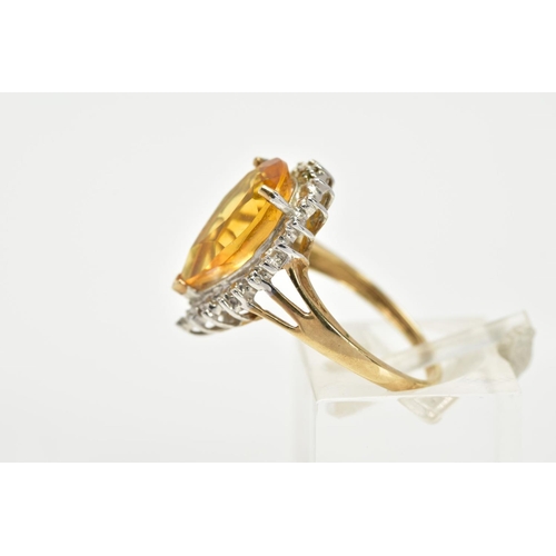 65 - A 9CT GOLD CITRINE CLUSTER RING, designed with a central claw set, pear cut citrine, within a single... 