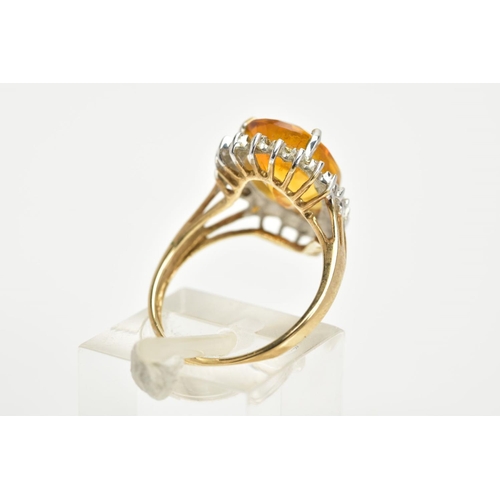 65 - A 9CT GOLD CITRINE CLUSTER RING, designed with a central claw set, pear cut citrine, within a single... 