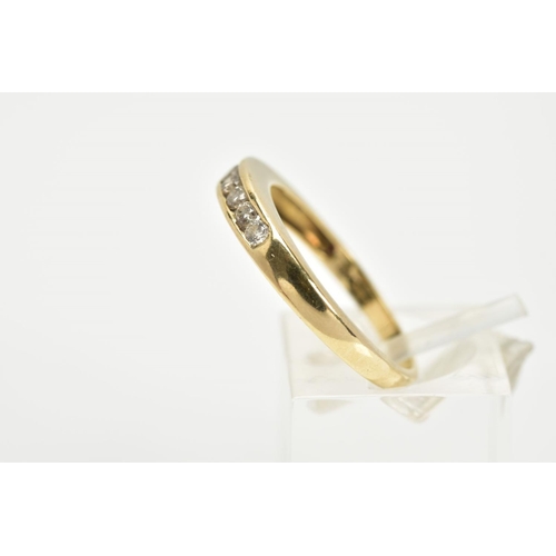 70 - A YELLOW METAL DIAMOND HALF ETERNITY RING, designed with a row of channel set round brilliant cut di... 