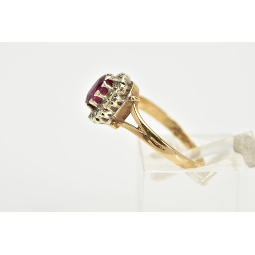 41 - A 9CT GOLD RUBY AND DIAMOND CLUSTER RING, the raised cluster designed with a claw set oval cut ruby,... 