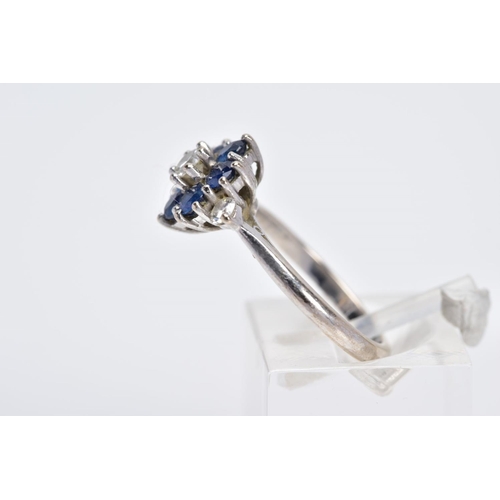 104 - AN 18CT WHITE GOLD DIAMOND AND SAPPHIRE CLUSTER RING, the raised cluster designed with a central rou... 