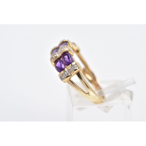 11 - A 9CT GOLD AMETHYST AND DIAMOND HALF HOOP RING, designed with three columns each set with two oval c... 