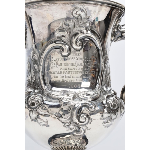 25 - A SILVER TROPHY CUP WITH STAND, the double handled trophy cup of a foliate and scroll detailed desig... 