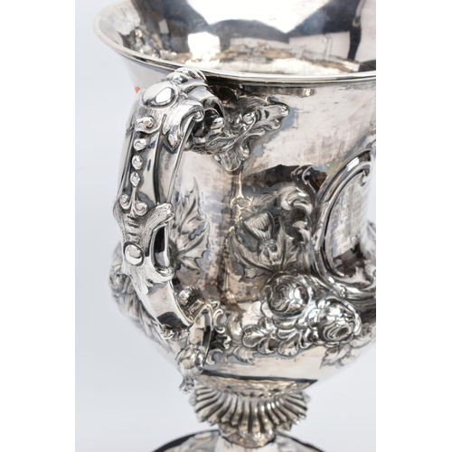 25 - A SILVER TROPHY CUP WITH STAND, the double handled trophy cup of a foliate and scroll detailed desig... 