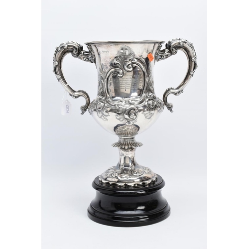 25 - A SILVER TROPHY CUP WITH STAND, the double handled trophy cup of a foliate and scroll detailed desig... 