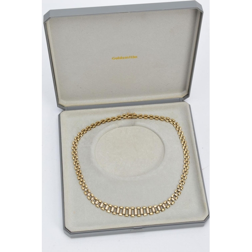 26 - A TWO TONE GOLD GATE NECKLET, of yellow and white gold, fitted with an integrated box clasp hallmark... 