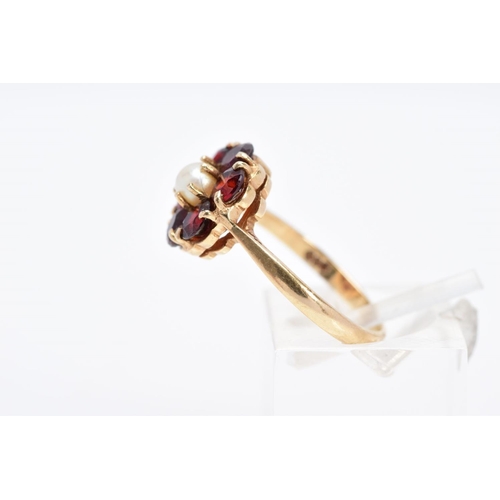 28 - A 9CT GOLD GARNET AND PEARL CLUSTER RING, designed with a central single cultured pearl, within a ci... 