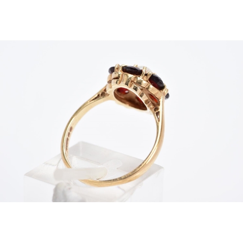 28 - A 9CT GOLD GARNET AND PEARL CLUSTER RING, designed with a central single cultured pearl, within a ci... 