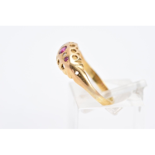 29 - A YELLOW METAL FIVE STONE RUBY AND DIAMOND RING, designed as a row of three circular cut rubies inte... 