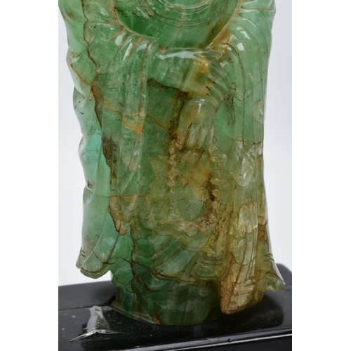 38 - TWO ORIENTAL CARVED FIGURES, believed to be green fluorite, each with a wooden base (one base unatta... 