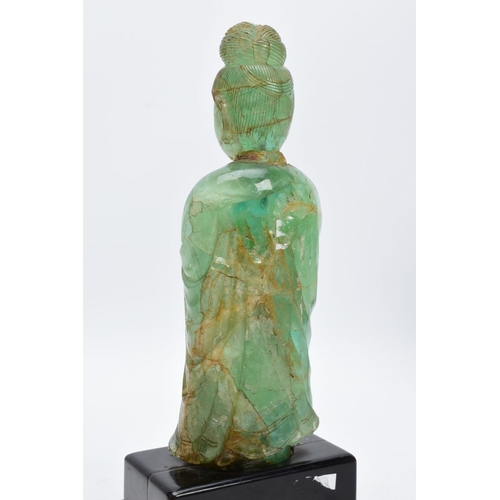 38 - TWO ORIENTAL CARVED FIGURES, believed to be green fluorite, each with a wooden base (one base unatta... 