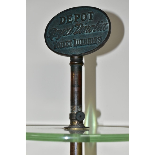 399 - AN EARLY 20TH CENTURY THREE TIER GLASS ADVERTISING DISPLAY STAND, the iron and worn brassed stand wi... 