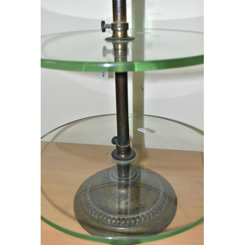 399 - AN EARLY 20TH CENTURY THREE TIER GLASS ADVERTISING DISPLAY STAND, the iron and worn brassed stand wi... 