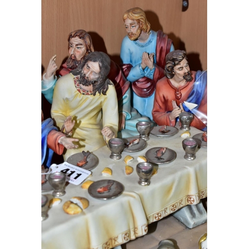 411 - A CAPODIMONTE FIGURE GROUP OF THE LAST SUPPER BY CORTESE, mounted on a giltwood base, marked towards... 