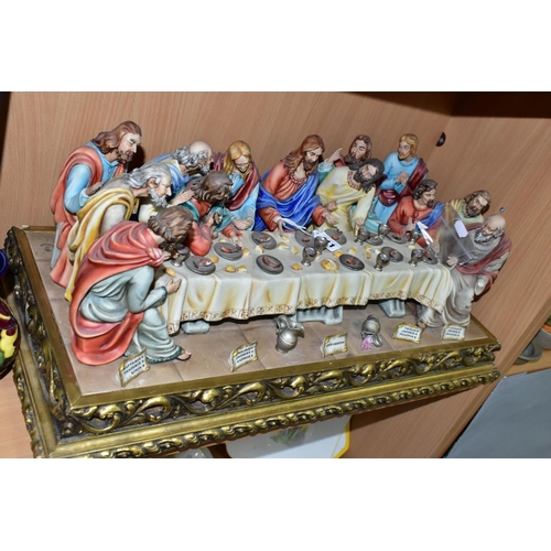 411 - A CAPODIMONTE FIGURE GROUP OF THE LAST SUPPER BY CORTESE, mounted on a giltwood base, marked towards... 