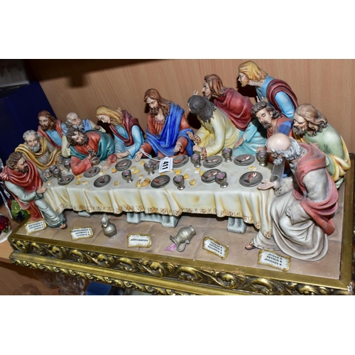 411 - A CAPODIMONTE FIGURE GROUP OF THE LAST SUPPER BY CORTESE, mounted on a giltwood base, marked towards... 