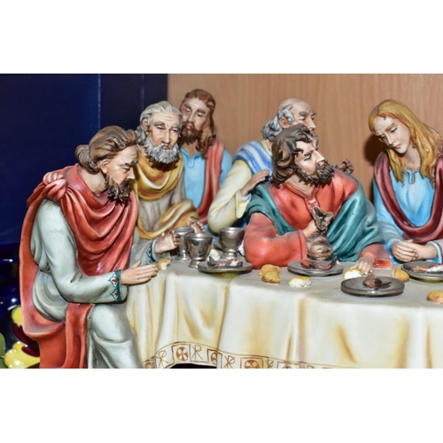 411 - A CAPODIMONTE FIGURE GROUP OF THE LAST SUPPER BY CORTESE, mounted on a giltwood base, marked towards... 