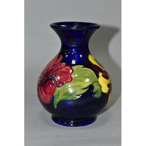 412 - A MOORCROFT POTTERY SQUAT BALUSTER VASE, yellow and red hibiscus on a blue ground, impressed marks, ... 