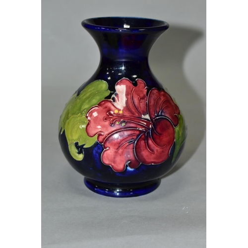 412 - A MOORCROFT POTTERY SQUAT BALUSTER VASE, yellow and red hibiscus on a blue ground, impressed marks, ... 