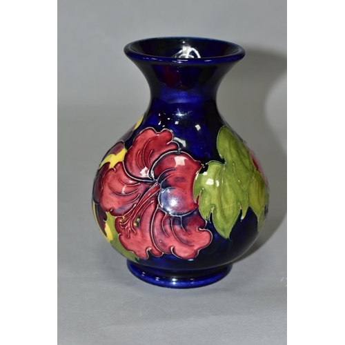 412 - A MOORCROFT POTTERY SQUAT BALUSTER VASE, yellow and red hibiscus on a blue ground, impressed marks, ... 