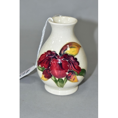 413 - A MOORCROFT POTTERY SQUAT BALUSTER VASE, Orchid decoration on a cream ground, impressed marks, heigh... 