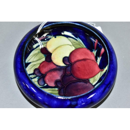 417 - A MOORCROFT POTTERY LIPPED BOWL, the interior decorated with Wisteria (plums) on a blue ground, impr... 