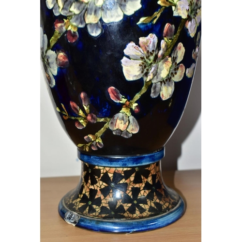 421 - A DOULTON LAMBETH FAIENCE BALUSTER VASE DECORATED BY MARY BUTTERTON, the dark blue ground painted wi... 