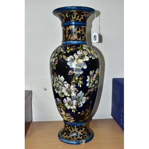 421 - A DOULTON LAMBETH FAIENCE BALUSTER VASE DECORATED BY MARY BUTTERTON, the dark blue ground painted wi... 