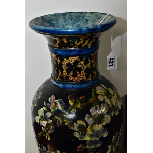 421 - A DOULTON LAMBETH FAIENCE BALUSTER VASE DECORATED BY MARY BUTTERTON, the dark blue ground painted wi... 