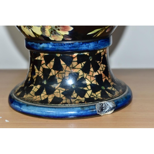 421 - A DOULTON LAMBETH FAIENCE BALUSTER VASE DECORATED BY MARY BUTTERTON, the dark blue ground painted wi... 