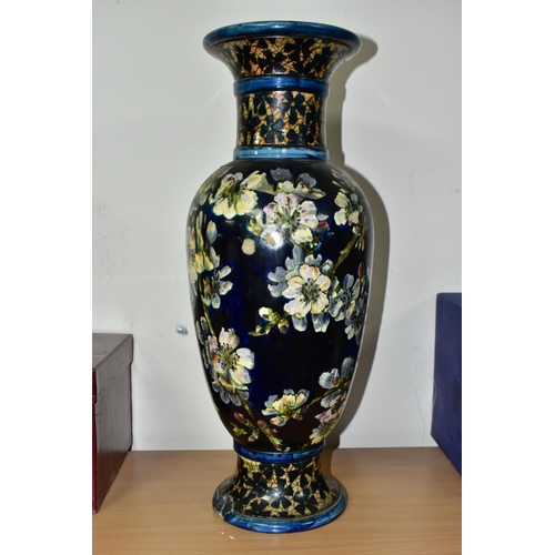 421 - A DOULTON LAMBETH FAIENCE BALUSTER VASE DECORATED BY MARY BUTTERTON, the dark blue ground painted wi... 