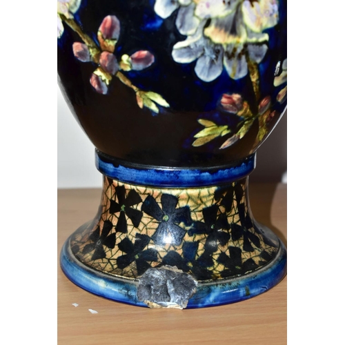 421 - A DOULTON LAMBETH FAIENCE BALUSTER VASE DECORATED BY MARY BUTTERTON, the dark blue ground painted wi... 