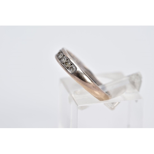 51 - AN 18CT WHITE GOLD DIAMOND HALF ETERNITY RING, designed with a row of seven channel set round brilli... 