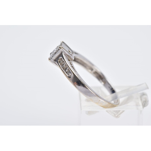 52 - AN 18CT WHITE GOLD DIAMOND RING, designed with a central raised square panel set with nine princess ... 