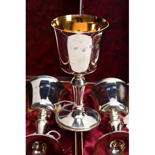 48 - A SET OF SIX BOXED ELIZABETH II SILVER GOBLETS, gilt interiors, on conical stem to a circular foot, ... 