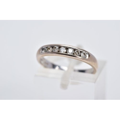 51 - AN 18CT WHITE GOLD DIAMOND HALF ETERNITY RING, designed with a row of seven channel set round brilli... 