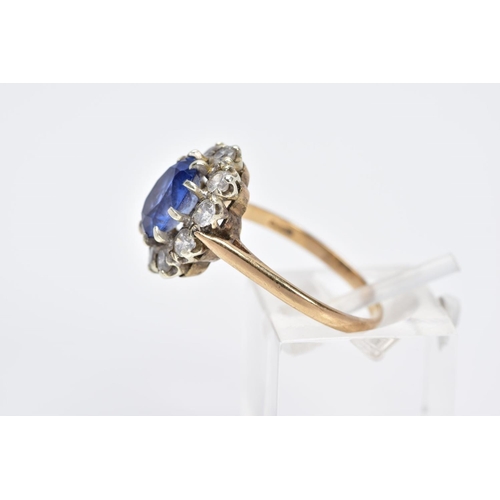 60 - A 9CT GOLD CLUSTER RING, designed with a central oval cut blue sapphire, within a circular cut cubic... 