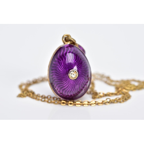 61 - A SILVER GILT PENDANT NECKLET, the pendant in the form of an egg with purple guilloche enamel and a ... 