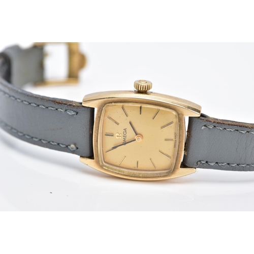 63 - A LADIES 9CT GOLD OMEGA WRISTWATCH, of a square shape, gold tone dial signed 'Omega', baton markers,... 