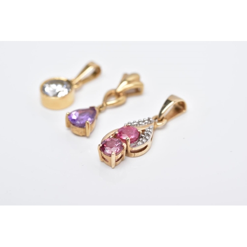 64 - THREE YELLOW METAL GEM SET PENDANTS, the first a drop set with two circular cut pink sapphires with ... 