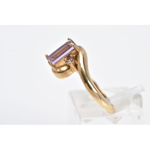 8 - A 9CT GOLD AMETHYST RING, of cross over design, set with a central rectangular cut amethyst flanked ... 