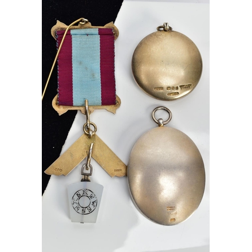 92 - A MASONIC MEDAL AND TWO MASONIC PENDANTS, the gilt metal and silver gilt medal, fitted on a burgundy... 