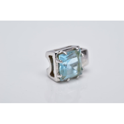 106 - A WHITE METAL BLUE TOPAZ PENDANT, of a square shape, designed with a claw set square cut blue topaz ... 