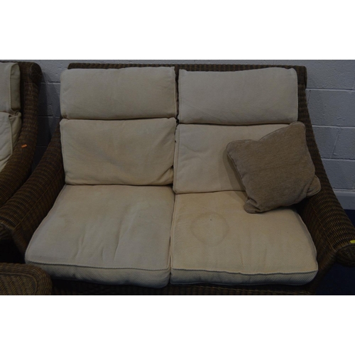 1349 - A WICKER THREE PIECE LOUNGE SUITE, with cream cushions, comprising a two seater settee, armchair and... 