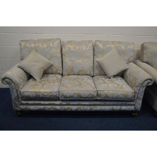 1350 - AN UPHOLSTERED TWO PIECE LOUNGE SUITE, on turned front legs, comprising a gold floral upholstered th... 