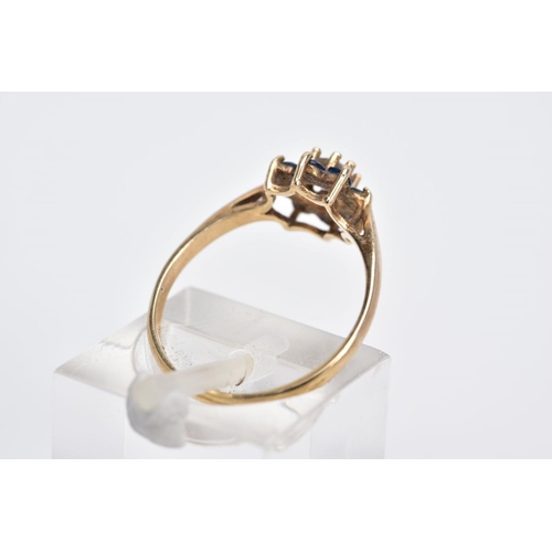 14 - A 9CT GOLD CLUSTER RING, the raised cluster designed with a central circular cut colourless stone as... 