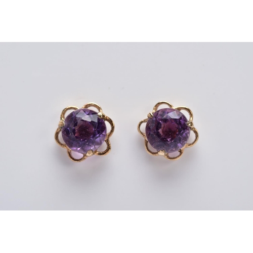 34 - A PAIR OF 9CT GOLD AMETHYST EARRINGS, each designed with a central circular cut amethyst within an o... 