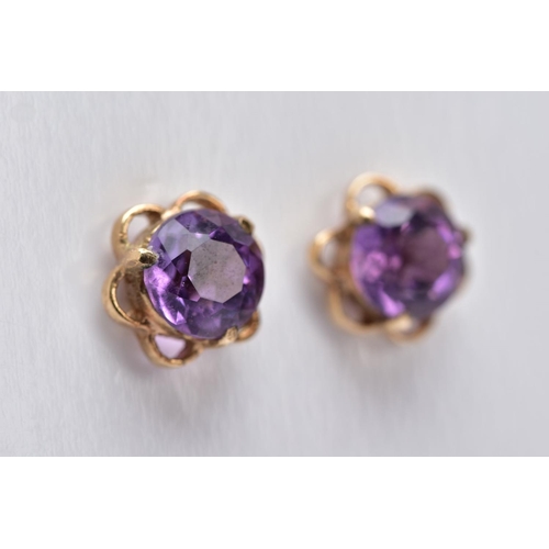 34 - A PAIR OF 9CT GOLD AMETHYST EARRINGS, each designed with a central circular cut amethyst within an o... 