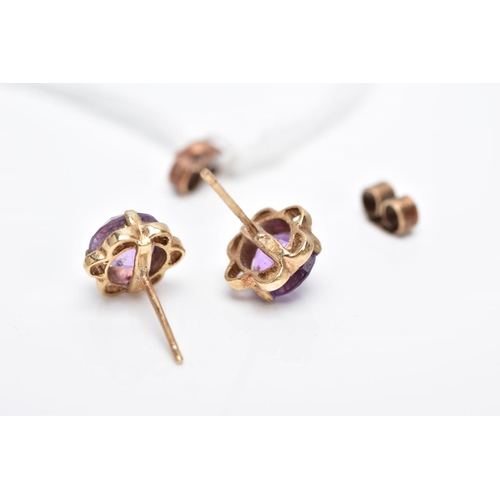 34 - A PAIR OF 9CT GOLD AMETHYST EARRINGS, each designed with a central circular cut amethyst within an o... 